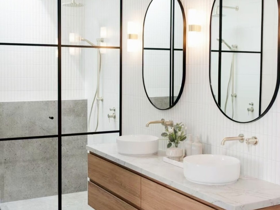 a minimalist bathroom with brushed gold tapware and accents