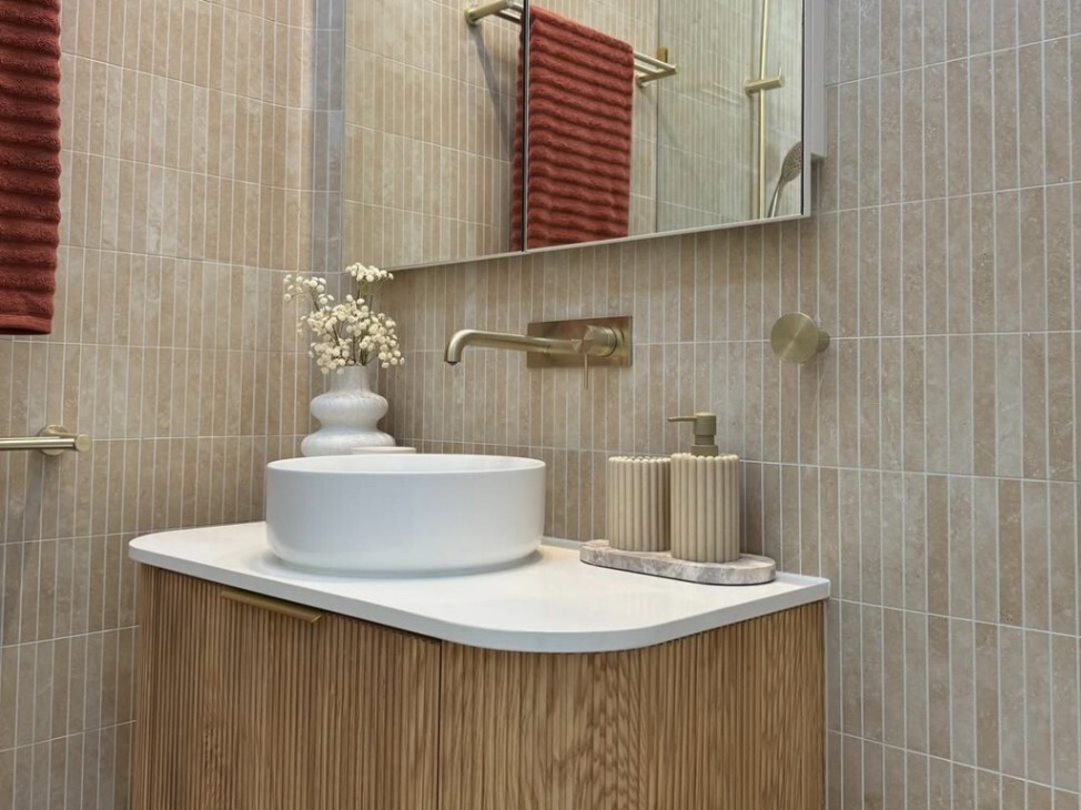 creamy-toned Japandi bathroom with the luxurious brushed gold tap