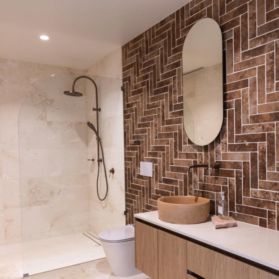 Dahlia Estate bathroom with herringbone tiles, earthy colour palette, and Nero’s bathroom tapware
