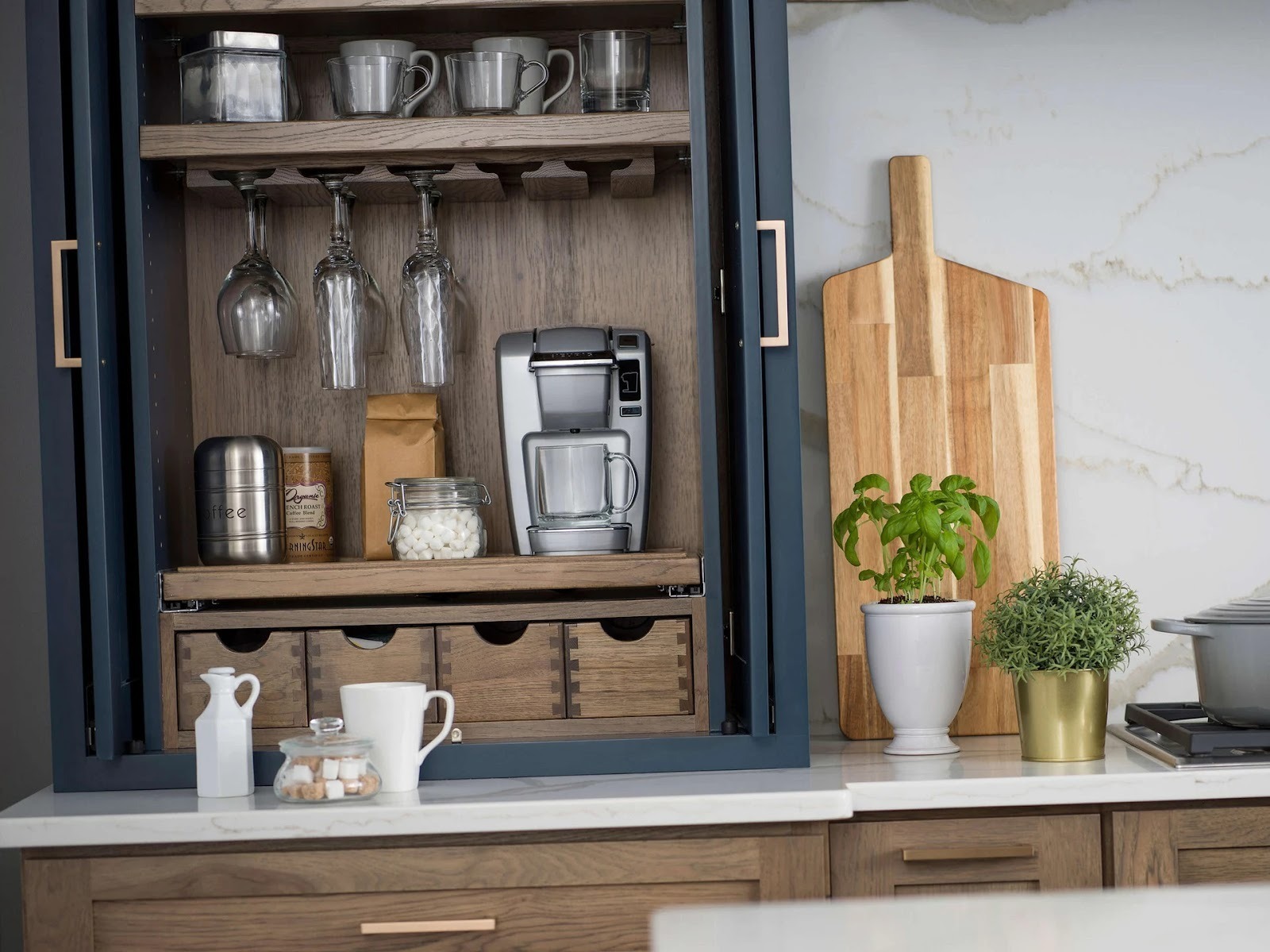 hidden home coffee station with recessed cabinetry and sliding doors
