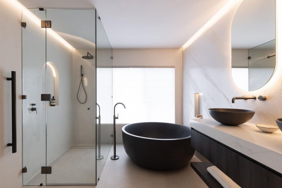 modern Australian bathroom with marble vanity top, black cabinetry and metal fixtures, and LED lighting