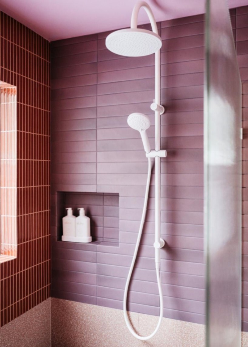 Nero Tapware’s white twin shower in a purple bathroom